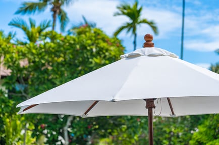 selective-focus-point-umbrella-with-coconut-palm-tree-background-holiday-vacation